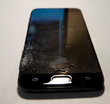 Phone with a broken screen Stock Photos