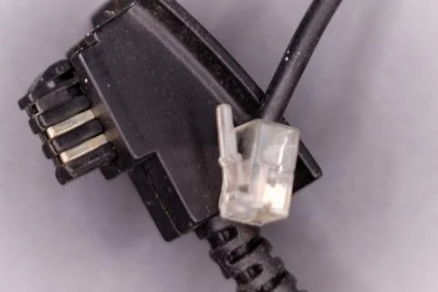 Phone cable connector with rj11 plug close-up Stock Photos