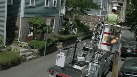 A Phone Cable Internet Utility Worker In A Bucket Lifted Up Examining An Electri 库存影片 76767433