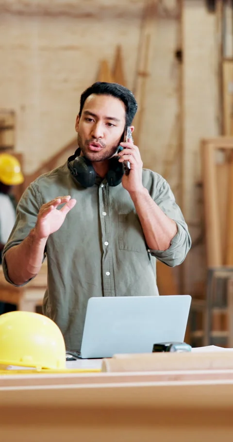 Phone call, argument and carpenter with laptop in workshop for delivery Stock Footage 331839663