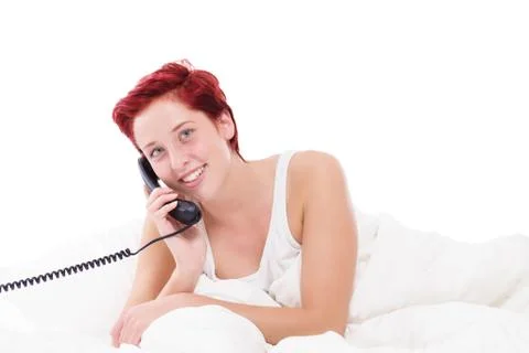 Phone call in bed Stock Photos