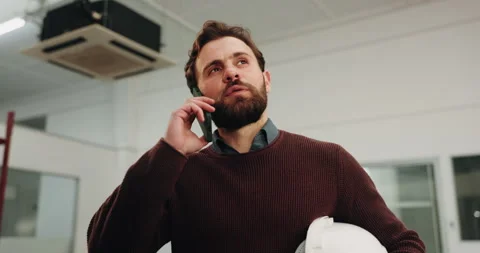 Phone call, building and man with helmet for inspection, renovation update and Stock Footage 341588429