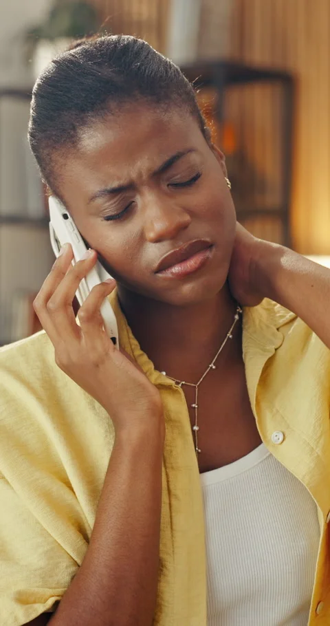 Phone call, communication and black woman on sofa with neck pain, injury or bad Stock Footage 337460650