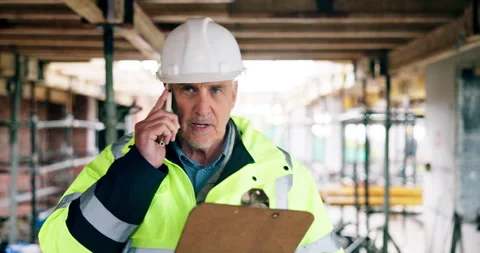 Phone call, engineer and man at construction site with checklist, walk or chat Stock Footage 337042341