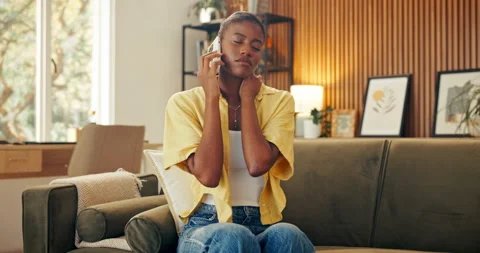 Phone call, talking and black woman on sofa with neck pain, injury and Stock Footage 337495426