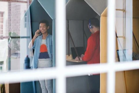 Phone call, technology and window with designer people in creative workplace for Stock Photos
