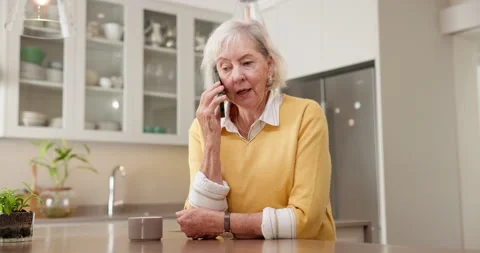 Phone call, upset and senior woman in kitchen for conversation, network issue or Stock Footage 345703043