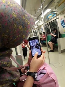 Phone Camera Captures Busy Train Passengers Daily Commute Scene. Singapore,.. Stock Photos