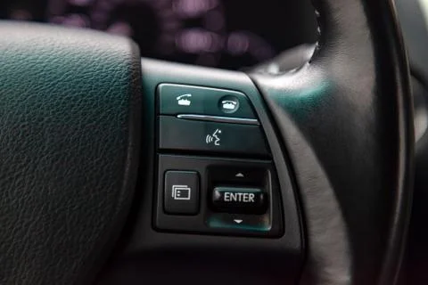 Phone control buttons via bluetooth on the steering wheel of a car close-up,  Stock Photos