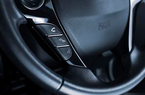 Phone control buttons in the multimedia control panel on steering wheel. Stock Photos