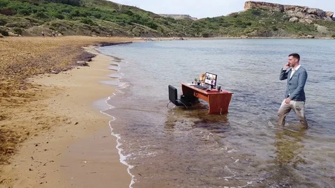 Phone Conversation on the Beach while Working Remotely Covid 19 Видео 128329562