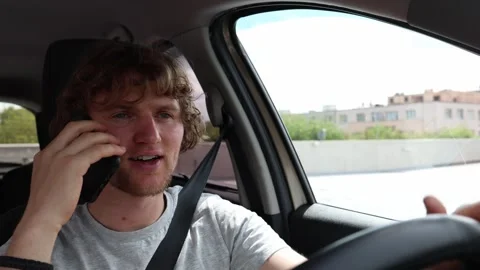 Phone conversation creates dangerous situations while driving in city traffic Stock Footage 343720397