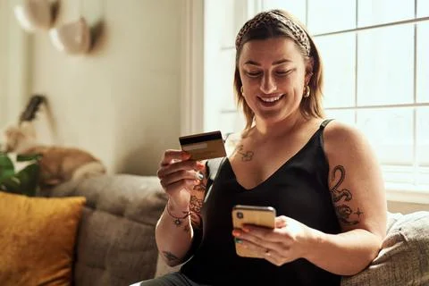 Phone, credit card and woman on sofa online shopping, e commerce and fintech Stock Photos