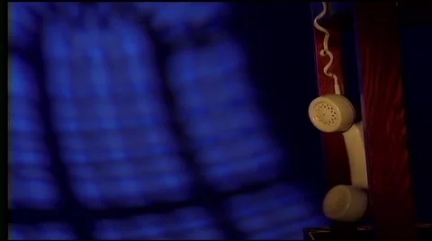 PHONE DANGLES OFF DESK at night Video stock 49304341