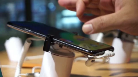 Phone display in shop with security system locked. Stock Footage 133752845