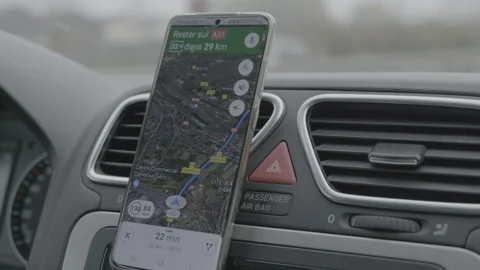 Phone displaying Google Maps app used as navigation in a car on the highway Stock Footage 165389862