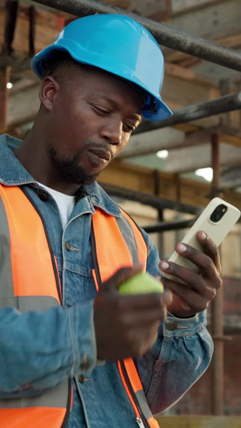 Phone, engineer and apple with black man on construction site for architect Stock Footage 340902493
