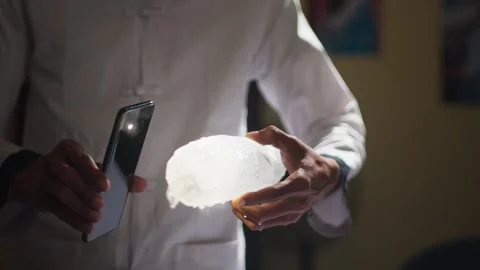 Phone Flashlight Illuminating Ice Cube Close Up Stock Footage 344236028