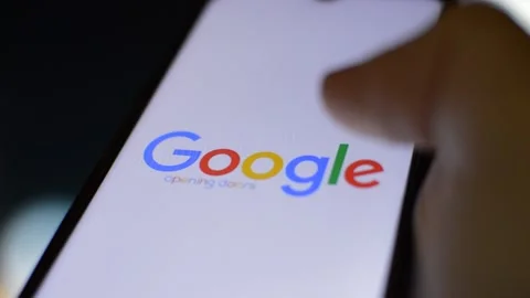 Phone with google on the display. man's hand hold phone with google app. Video stock 224092875