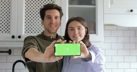 Phone Green Chroma Key Screen and Smiling into Camera. Mock-up. Real Estate Stock Footage 127645252