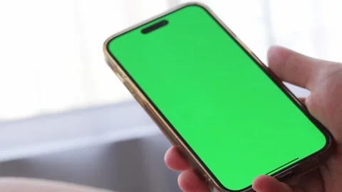 Phone with green chromakey screen in hand of male. High quality video Stock Footage 245432287