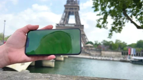 Phone with green Chromate screen on the background of the eiffel tower. in Paris Stock Footage 186418664