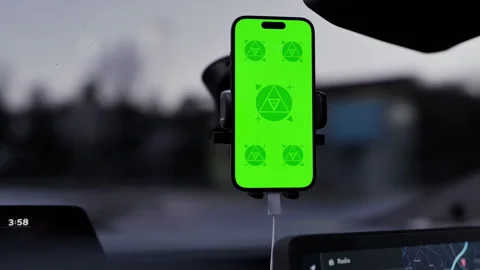 A phone with a green mockup screen is mounted on a car dashboard Stock Footage 292910345