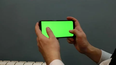 Phone with a green screen, background for video and games, screensaver, man, Stock Footage 168472829