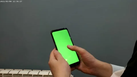 Phone with a green screen, background for video and games, screensaver, man, Stock Footage 168472874