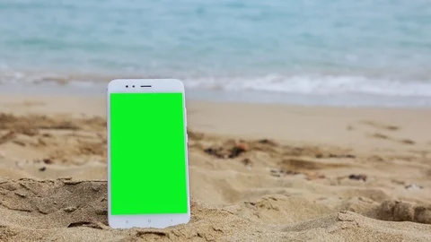 Phone with green screen on the beach 1 Stock Footage 126940747
