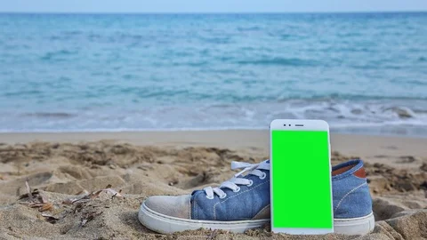 Phone with green screen on the beach 4 Stock Footage 126991691