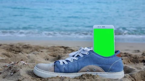 Phone with green screen on the beach 5 Stock Footage 126992395
