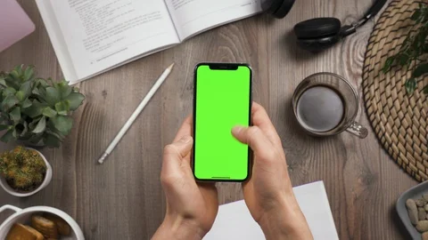 Phone with green screen chroma key in male hands. Thumb swipe up and tap likes Stock Footage 129314754