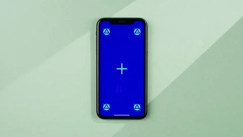 Phone with green screen chroma key on orange background close up, top view Stock Footage 247919659