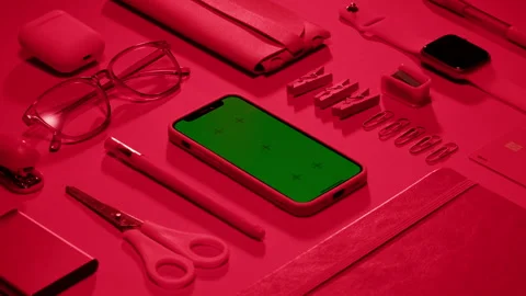 Phone with green screen chroma key on red and pink background close up, top view Stock Footage 253576566