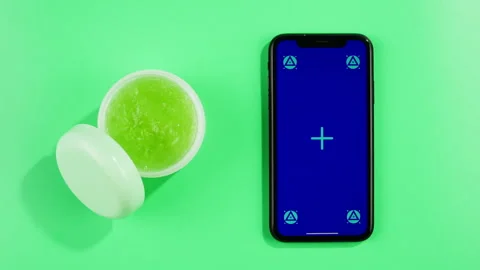 Phone with green screen chroma key with Fresh ripe avocados with cream and Stock Footage 254432749