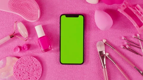Phone with green screen chroma key among fashion pink women stylish accessories Stock Footage 260761555