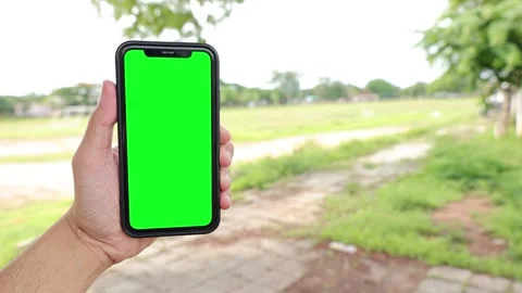 Phone, green screen, green screen of phone, hand holding smartphone green screen Stock Footage 243484716