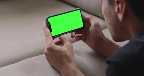 Phone with green screen in Landscape Horizontal Orientation. Hipster at Home.  Stock Footage 138295002