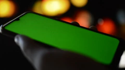 Phone green screen on a man's hand in a night city background Stock-Footage 201666048
