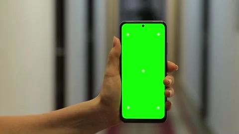 Phone with green screen mock up close up, Blurred hotel corridor on background Stock Footage 301893327