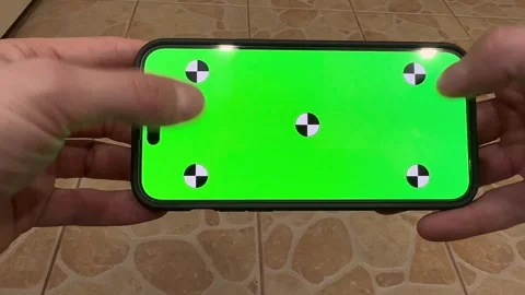 Phone with a green screen pressing the screen with thumbs Stock Footage 282532077