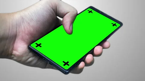 Phone with greenscreen hand with matte background 4k Stock Footage 257656568