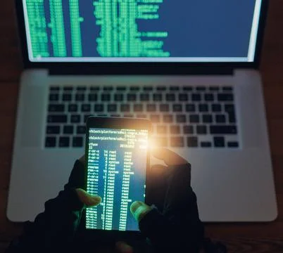 Phone, hacker and coding on laptop at night for hacking software database Fotos de archivo