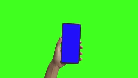 Phone in the hand close up isolated at green background. Phone screen is blue ch Stock Footage 198296875
