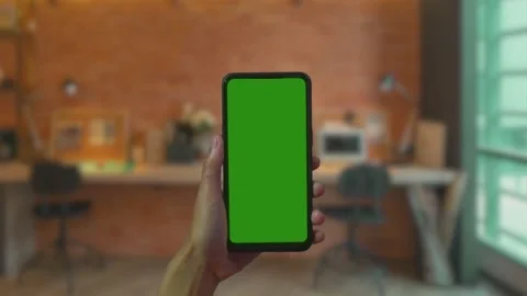 Phone in the hand close up. Phone screen is green chroma key, Footage for mobile Stock Footage 169210299