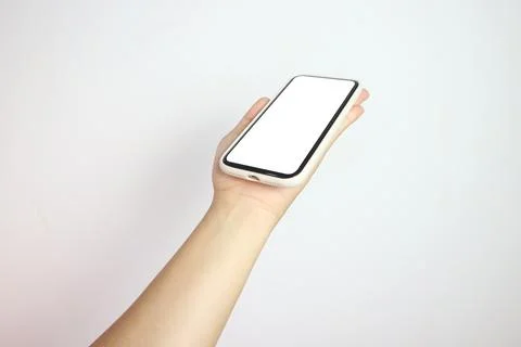 Phone in hand isolate on white background. A modern smartphone lies on the .. Stock Photos