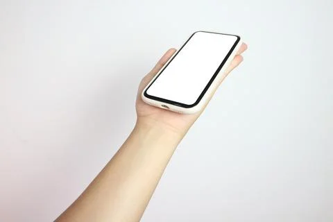 Phone in hand isolate on white background. A modern smartphone lies on the .. Stock Photos