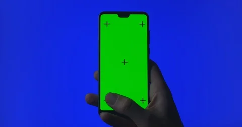 Phone in hand isolated on a green background. Phone screen - green chroma key Stock Footage 128677513