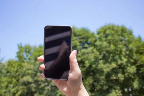 Phone in hand on the sky backgrounds Foto stock